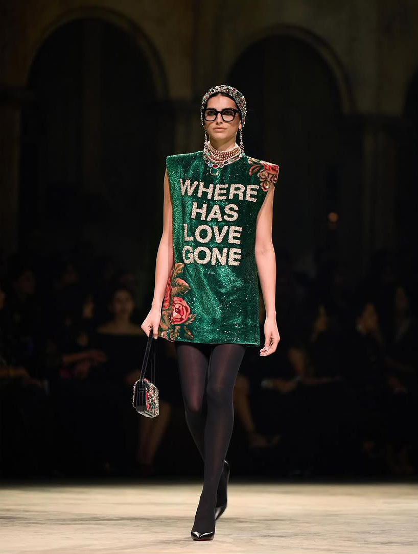 A green slogan shift dress shimmering with sequin embellishments